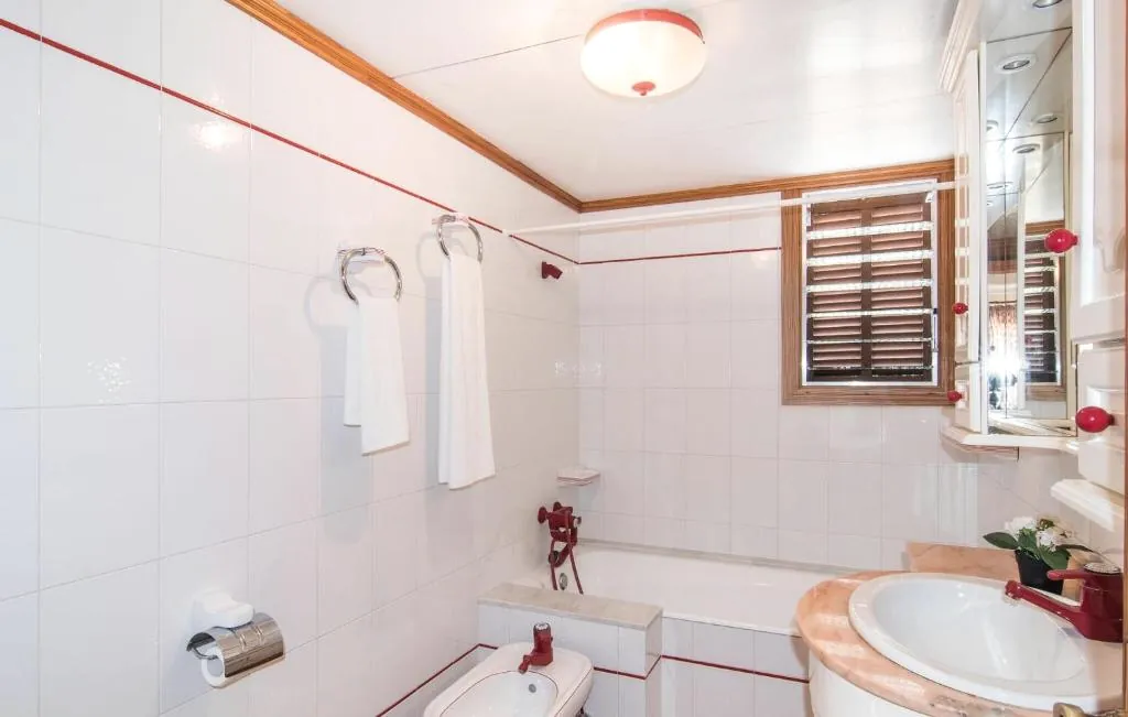 Bathroom with bathtub and patterned tile detail