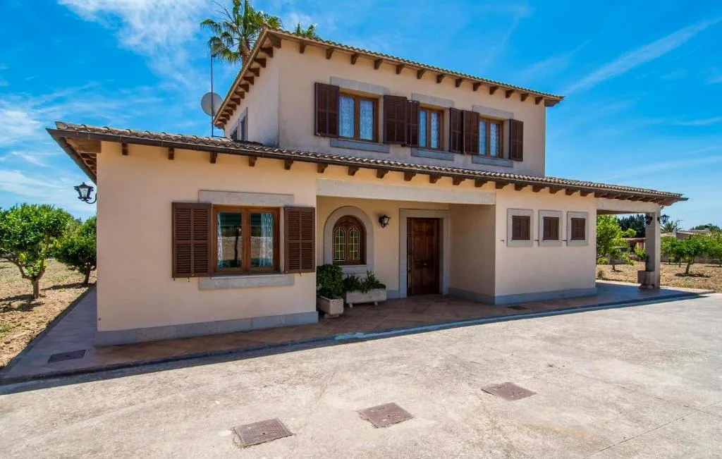 Front view of Finca Bloom with shutters, tiled roof, and orchard surroundings