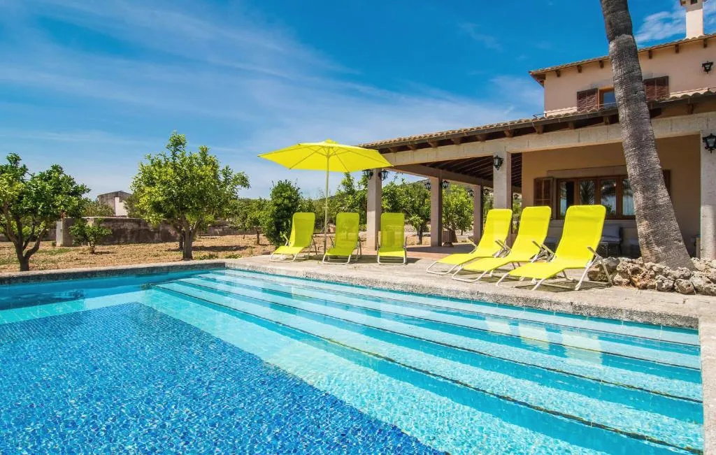 Private pool with sun loungers and the chalet beyond