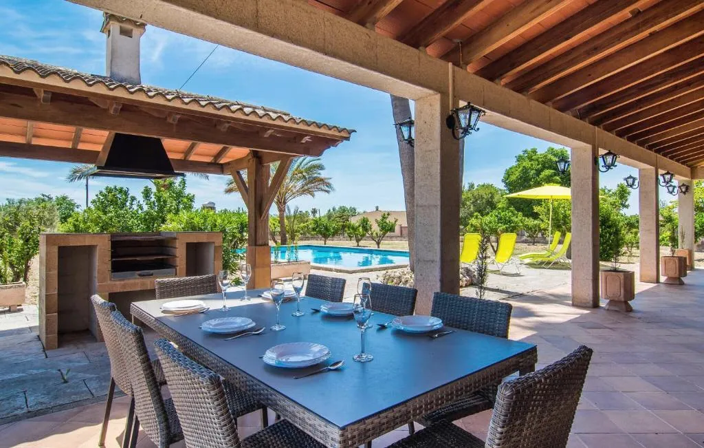 Terrace dining table beside the BBQ and pool