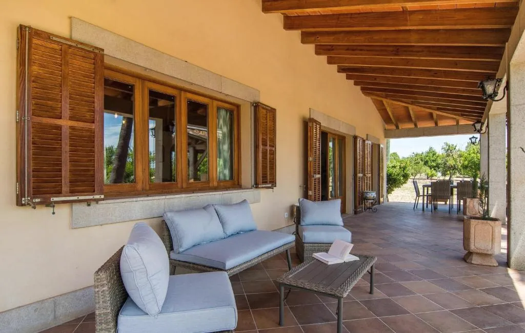 Shaded terrace lounge beside Mallorcan shutters